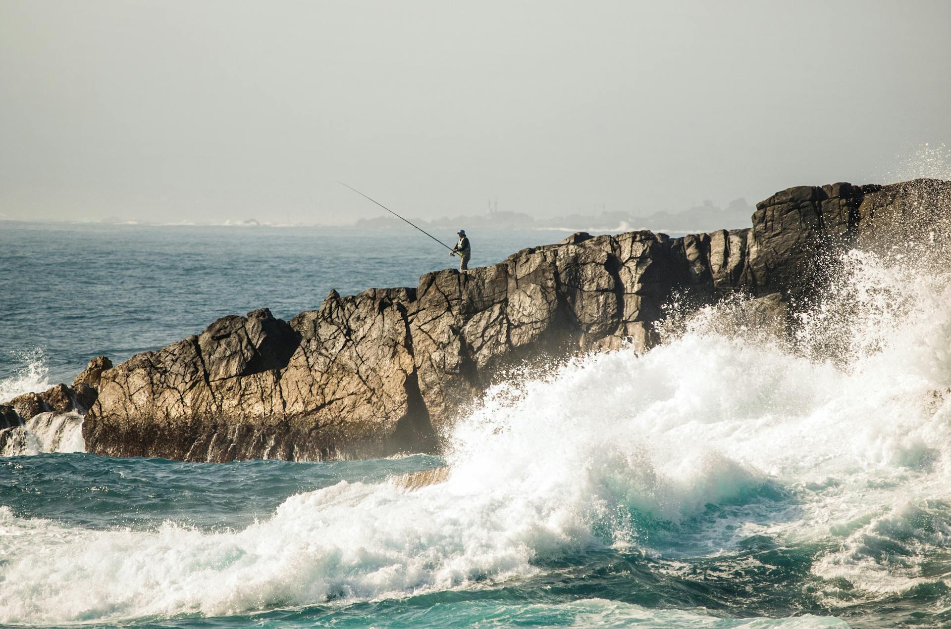 Waves at the beach hitting rocky shore